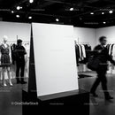 Blank white poster stand in modern fashion boutique