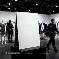Blank white poster stand in modern fashion boutique