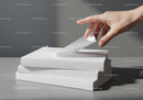 Hand flipping page of blank book on stack