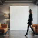Blurred woman walking through modern lobby with leather sofas
