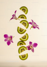 Floating kiwi slices with pink orchid flowers