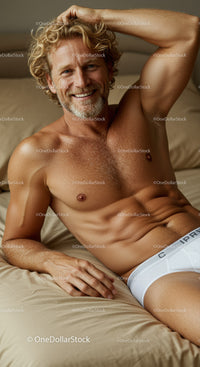 Relaxed man smiling while lounging on beige bed