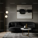 Modern living room with black sofa and abstract art