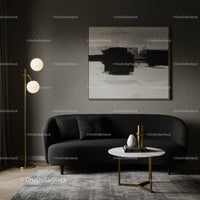Modern living room with black sofa and abstract art