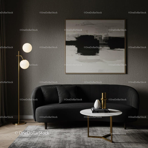 Modern living room with black sofa and abstract art