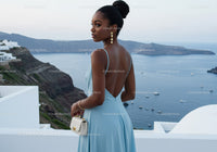 Elegant woman in blue dress overlooking sea view
