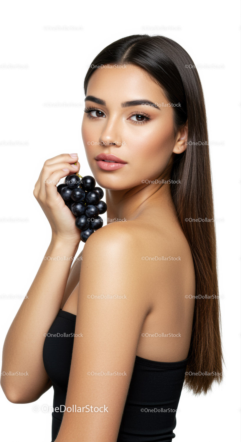Elegant Woman Holding Black Grapes with Long Brown Hair