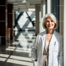 Senior Female Doctor in White Coat at Modern Medical Clinic
