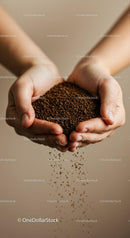 Hands gently holding and pouring instant coffee granules