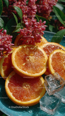 Fresh Sliced Oranges with Ice Cubes and Pink Flowers for Refreshing Enjoyment