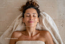 Relaxed Woman with Freckles Resting on Floor Enjoying Spa Day
