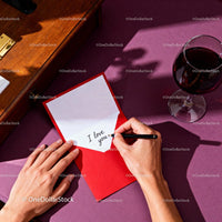 Writing a Love Note with Wine on Purple Table