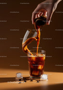 Pouring Coffee Cream into Iced Cold Brew Glass