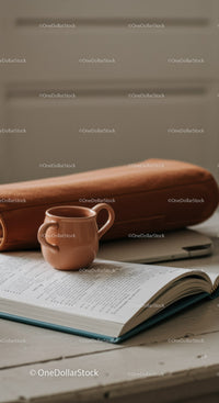 Ceramic Mug, Wooden Rolling Pin and Open Book on Cozy Study Table