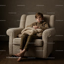Thoughtful boy sitting barefoot on cozy armchair