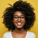 Happy Woman with Curly Hair and Glasses Against Yellow Background