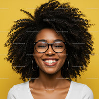 Happy Woman with Curly Hair and Glasses Against Yellow Background
