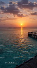 Beautiful Sunset Over Ocean with Pier and Cloudy Sky