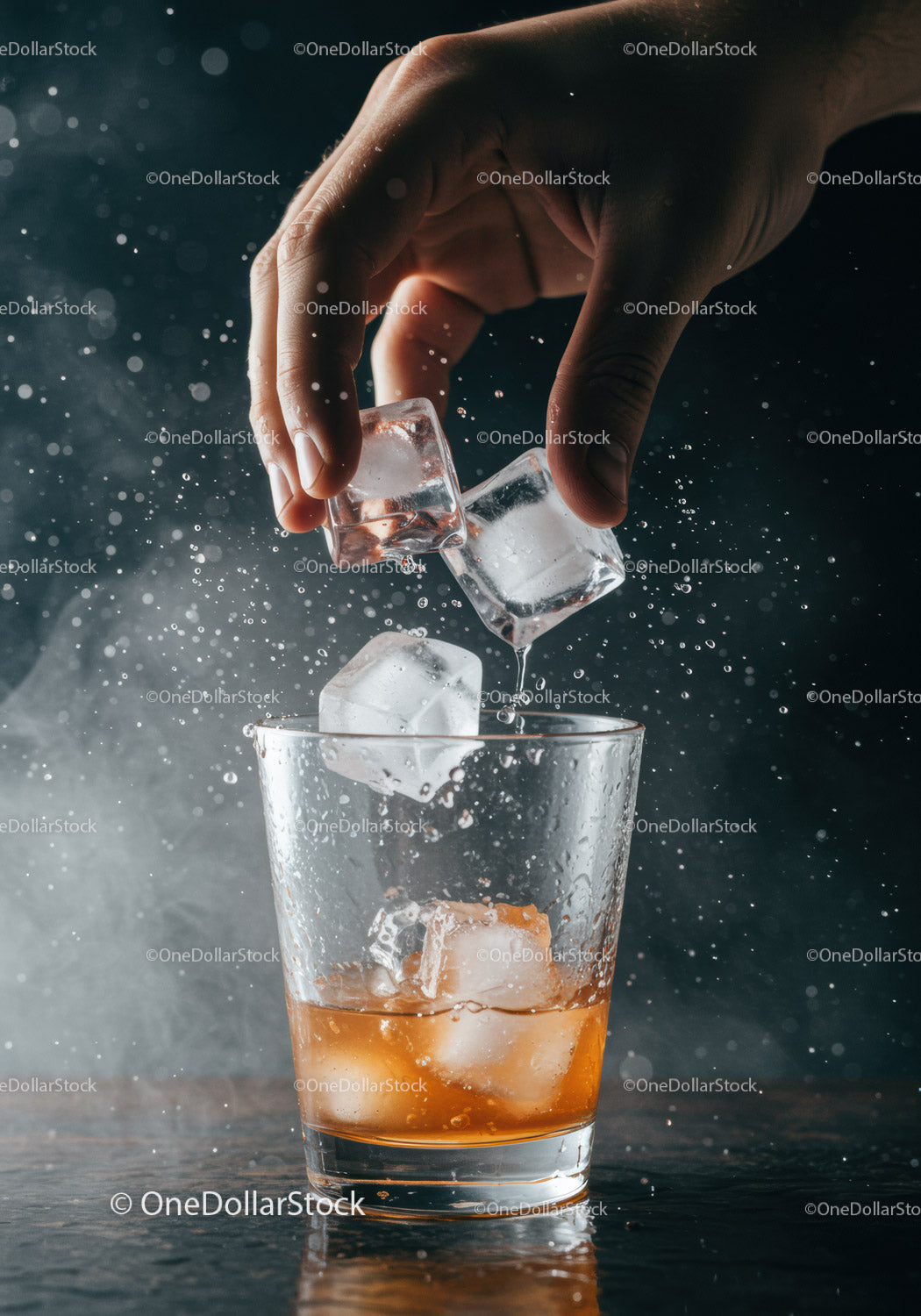 Hand Adding Ice Cubes to Whisky Glass with Splash