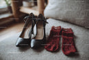 Chic Black Heels and a Red Lace Dress in a Cozy Bedroom Setting