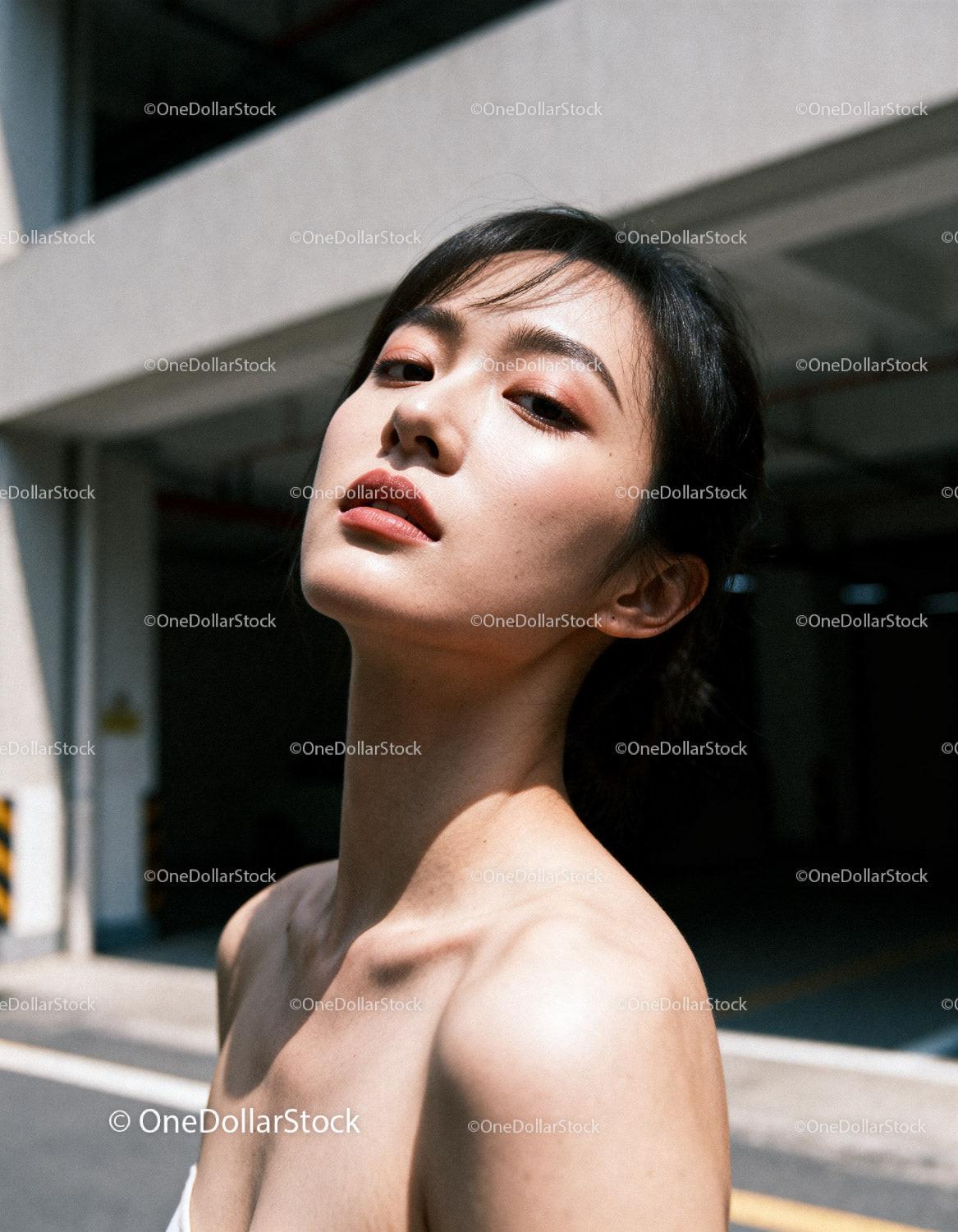Confident young woman posing with natural makeup outdoors