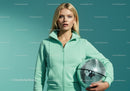 Young Woman in Mint Green Tracksuit Holding Disco Ball in Studio