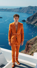Man in bright orange suit overlooking coastal cliffs and sea