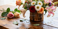 Rustic Wooden Vase with Diverse Fresh Flowers on Table