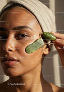 Young Woman Using Jade Roller for Skin Care and Relaxation