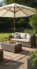 Elegant Outdoor Patio with Wicker Sofa and Large Garden Umbrella