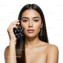 Beautiful Woman Holding Black Grapes with Fresh Skin and Calm Expression