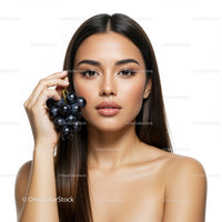 Beautiful Woman Holding Black Grapes with Fresh Skin and Calm Expression
