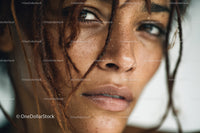 Close-up of a Woman with Freckles and Curly Hair Water droplets skin