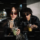 Stylish Women with Drinks in Urban Nightlife Setting