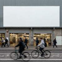 Busy urban street with pedestrians and cyclists passing shop