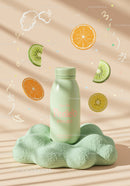 Minimalist bottle with fresh fruit slices and pastel backdrop