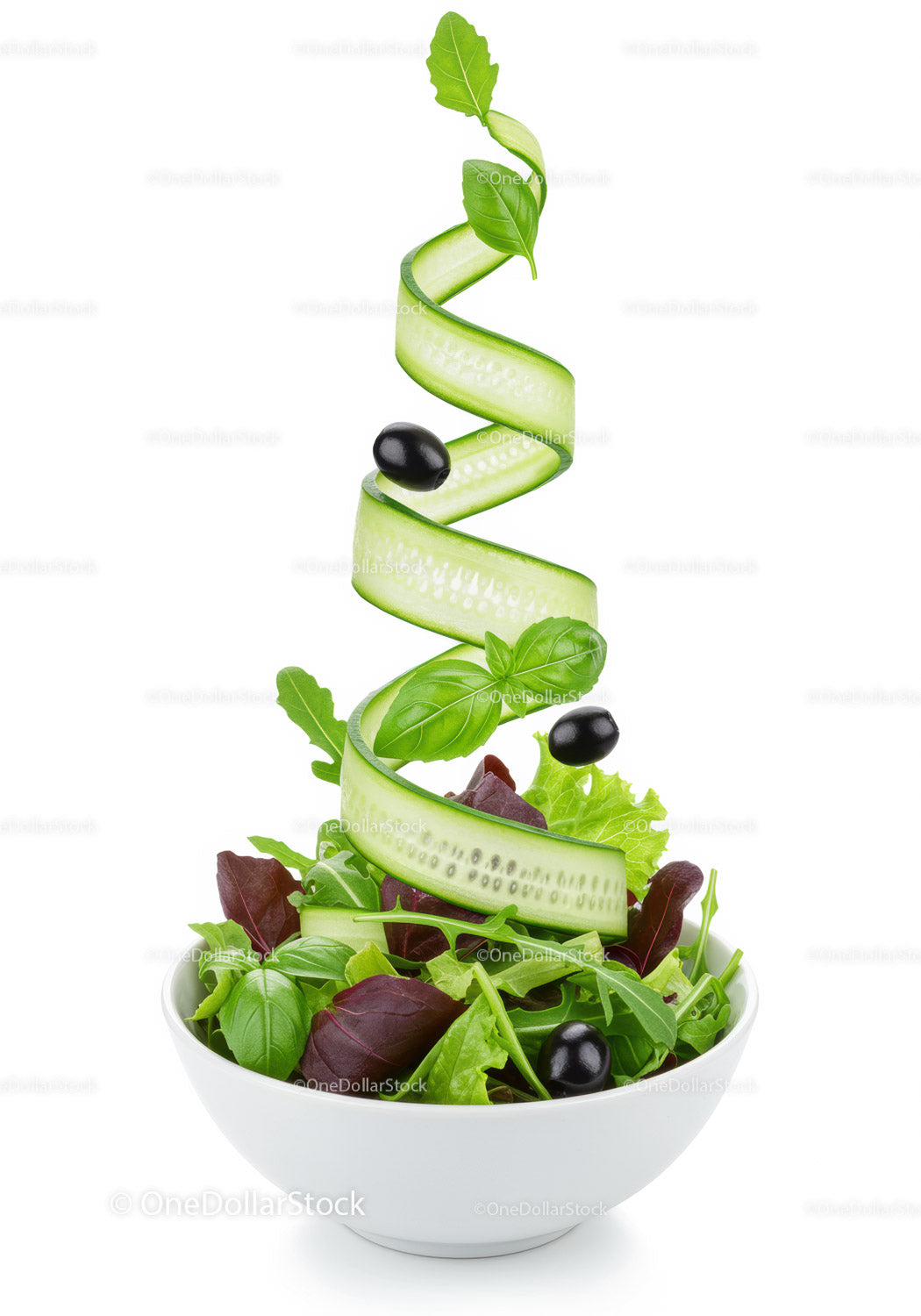 Fresh green salad with cucumber ribbons and black olives