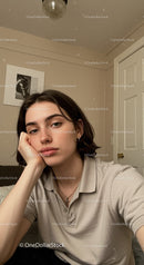 Young woman relaxing indoors with thoughtful expression
