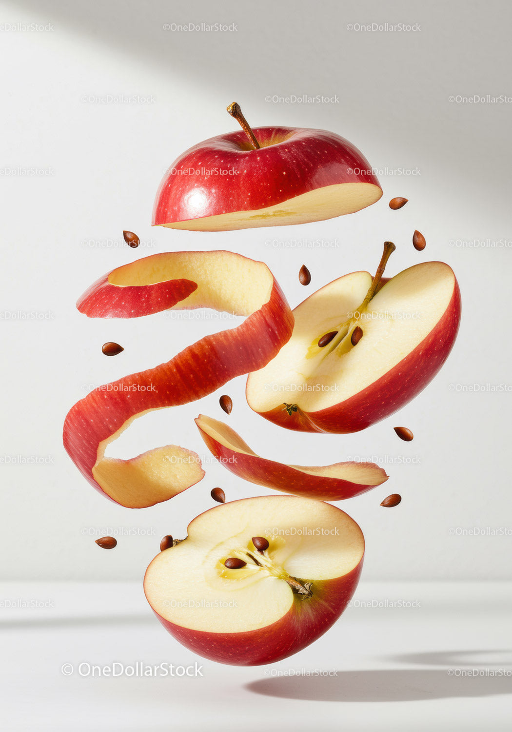 Fresh red apple sliced with peel and seeds floating