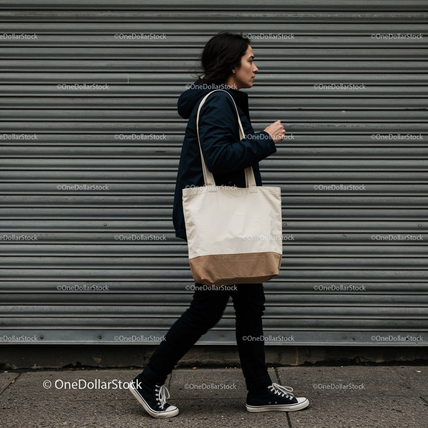 Casual woman walking with canvas tote bag in urban setting