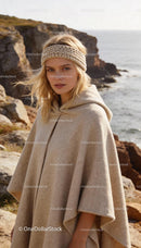 Blonde woman wearing knitted headband and cape outdoors
