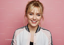 Bright Woman Smiling in Casual Jacket Against Pink Background