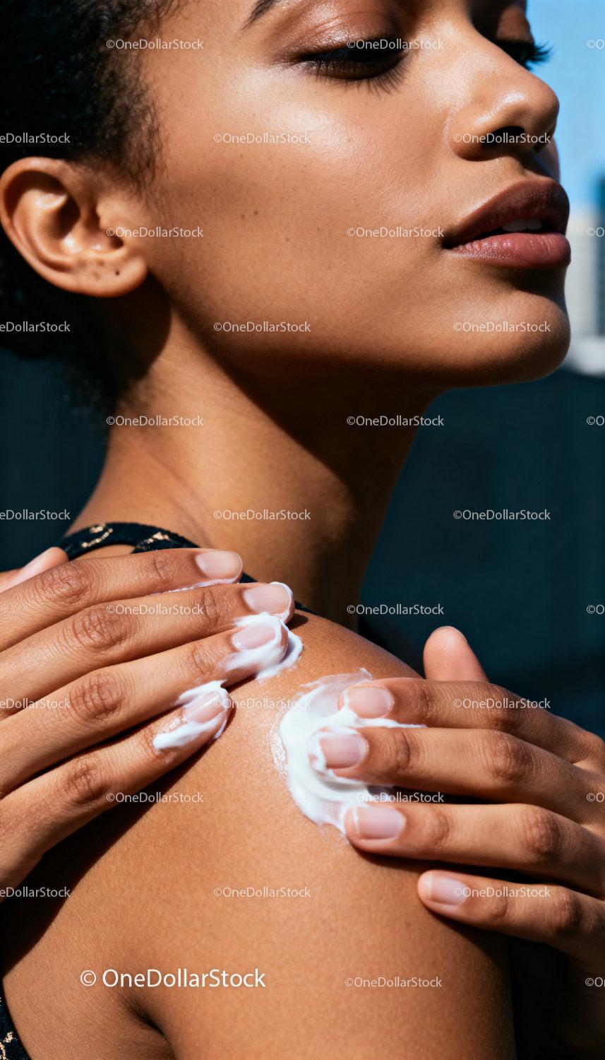 Woman Applying Cream to Smooth Shoulder Skin