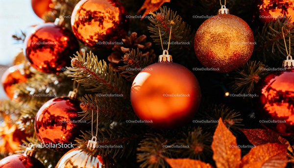 Close-up of red and orange Christmas ornaments on tree