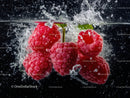 Fresh Raspberries Splashing in Water with Vibrant Red Color