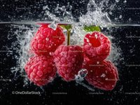 Fresh Raspberries Splashing in Water with Vibrant Red Color
