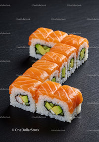 Fresh salmon sushi rolls with avocado and crab
