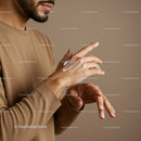 Close-Up of Man Applying Moisturizer to Hands for Skincare Routine