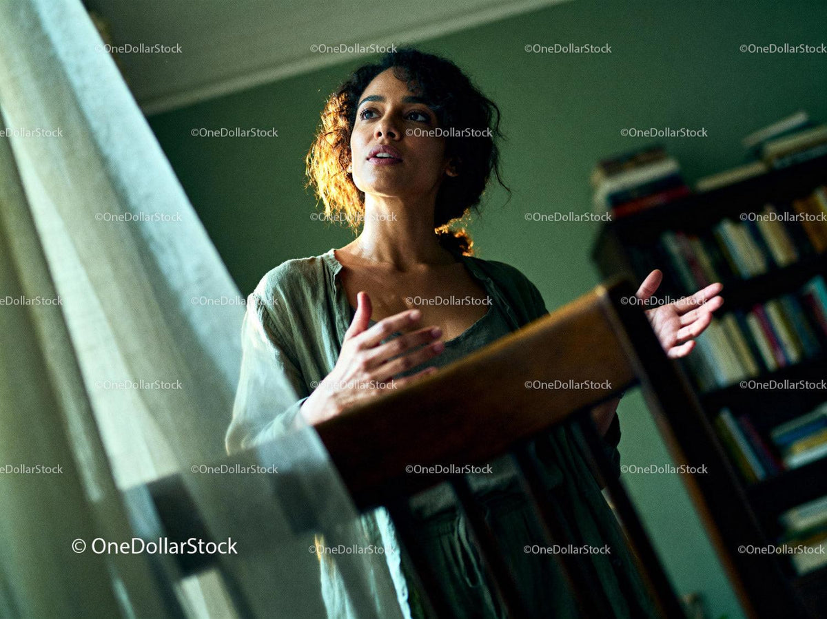 Woman speaking passionately by window with warm light