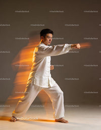 Martial artist in white uniform performing a powerful punch